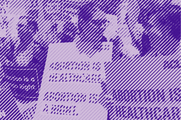 Two women in a crowd holding signs about abortion rights and abortion is healthcare.