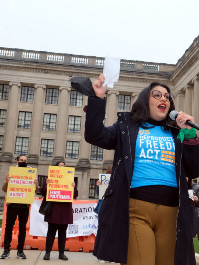 ACLU-NJ Campaign Strategist Alejandra Sorto speaks to the crowd at a rally outside the statehouse in Trenton, NJ.