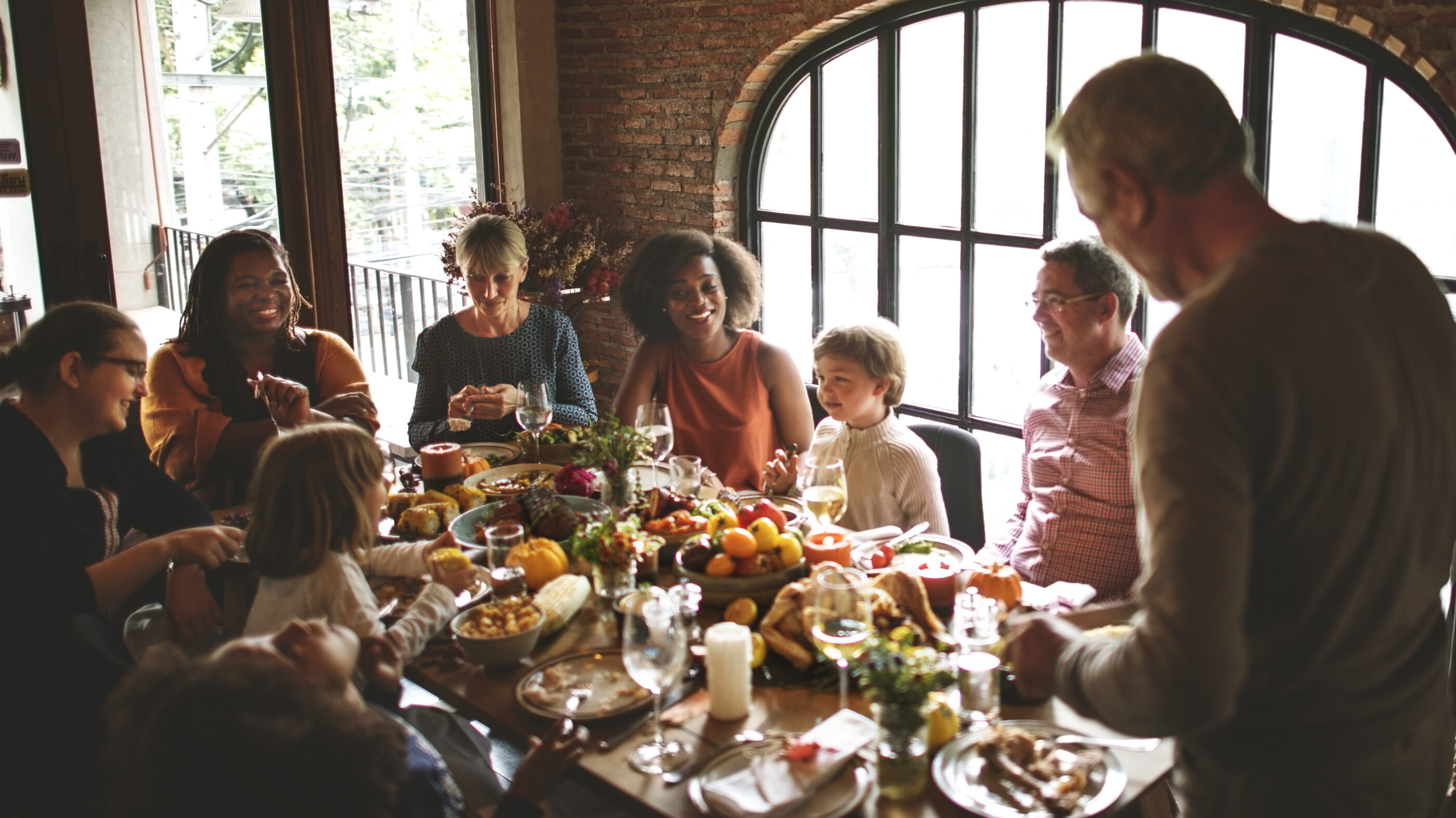 A family is gathered around a table for a holiday dinner.