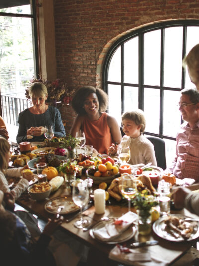 A family is gathered around a table for a holiday dinner.