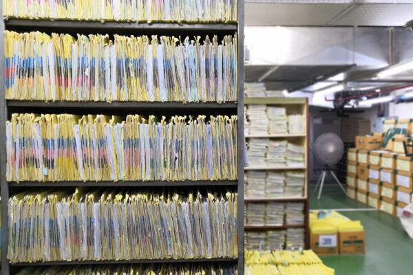A room with files packed on bookshelves in a room