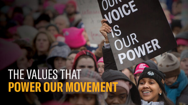 the front cover of the annual report that reads "the values that power our movement" with a protest image in the background.
