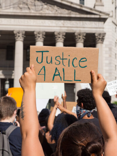 Hands holding up a sign with word