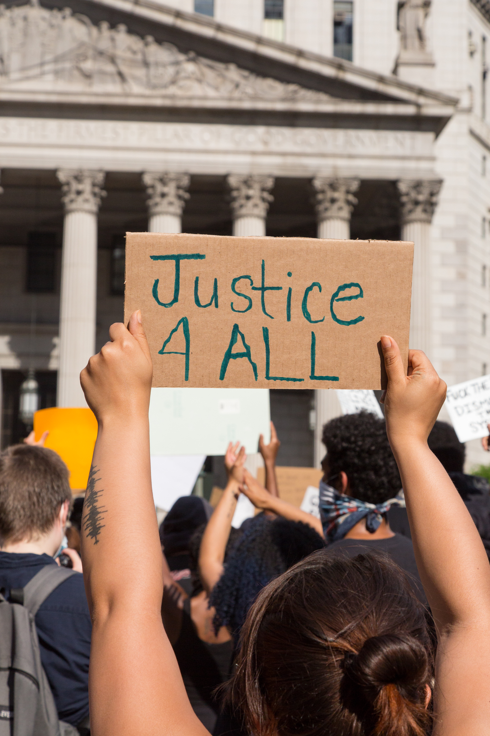 Hands holding up a sign with word