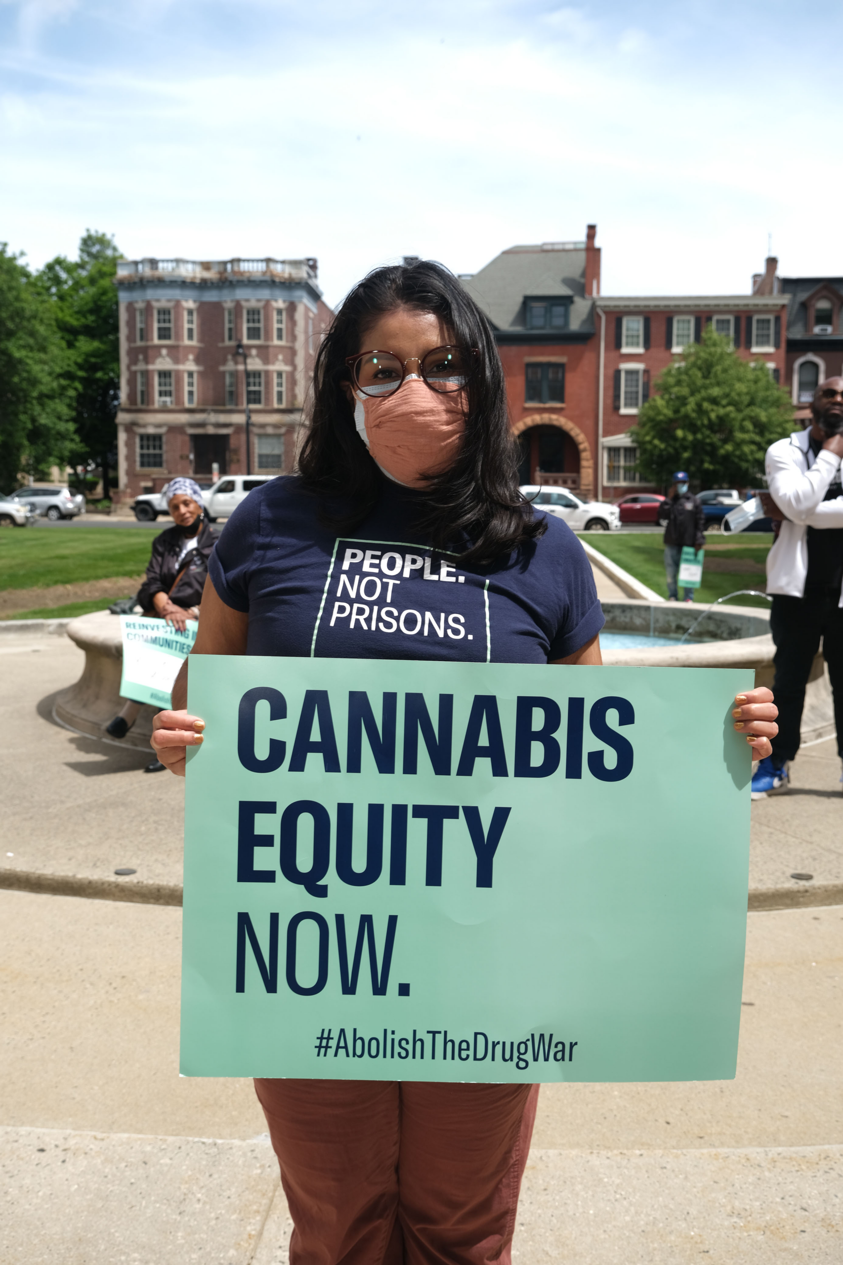 Woman holding sign that says