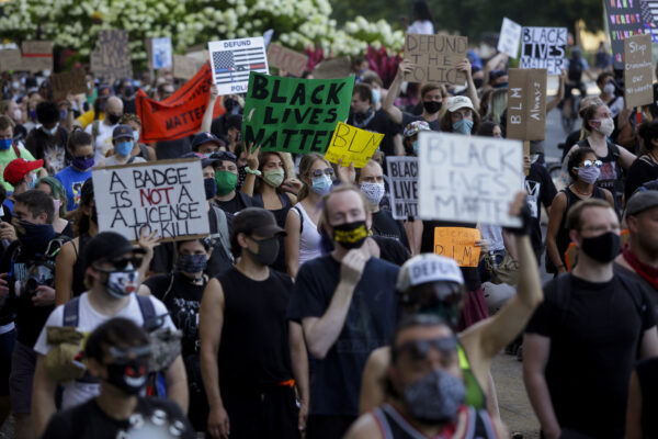 Protesters holding signs