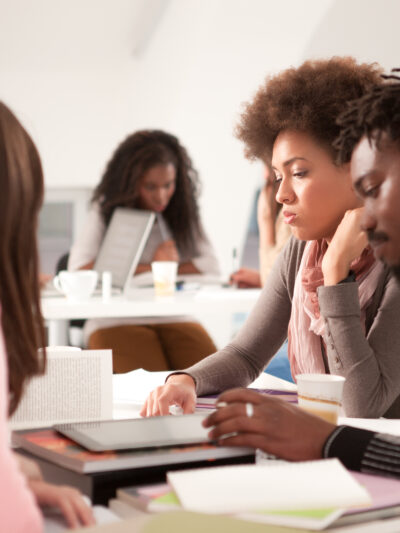 Multi-ethnic group of college students studying