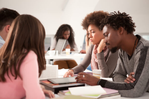 Multi-ethnic group of college students studying