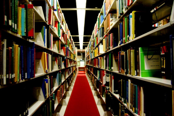Library shelves in dark lighting