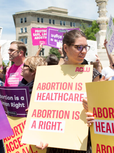 Protestors holding signs reading "abortion is healthcare. Abortion is a right"