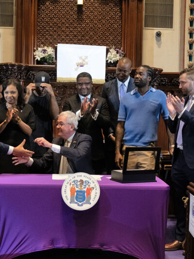 ACLU-NJ Executive Director shakes hands with New Jersey Governor Phil Murphy at the Clemency Executive Order Announcement.