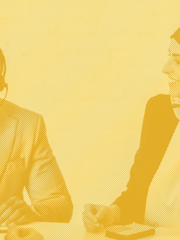 A man and a woman with headphones and mics sit at a table together with a yellow striped treatment applied