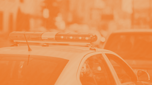 An image of a police car with a orange stripped treatment applied