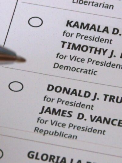 Hand marking an election ballot
