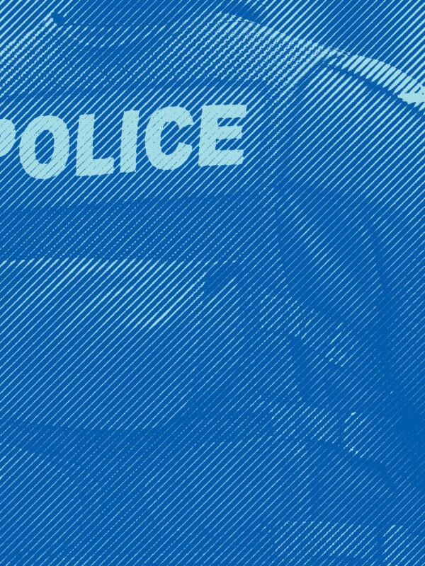 Single police officer standing and monitoring a crowd