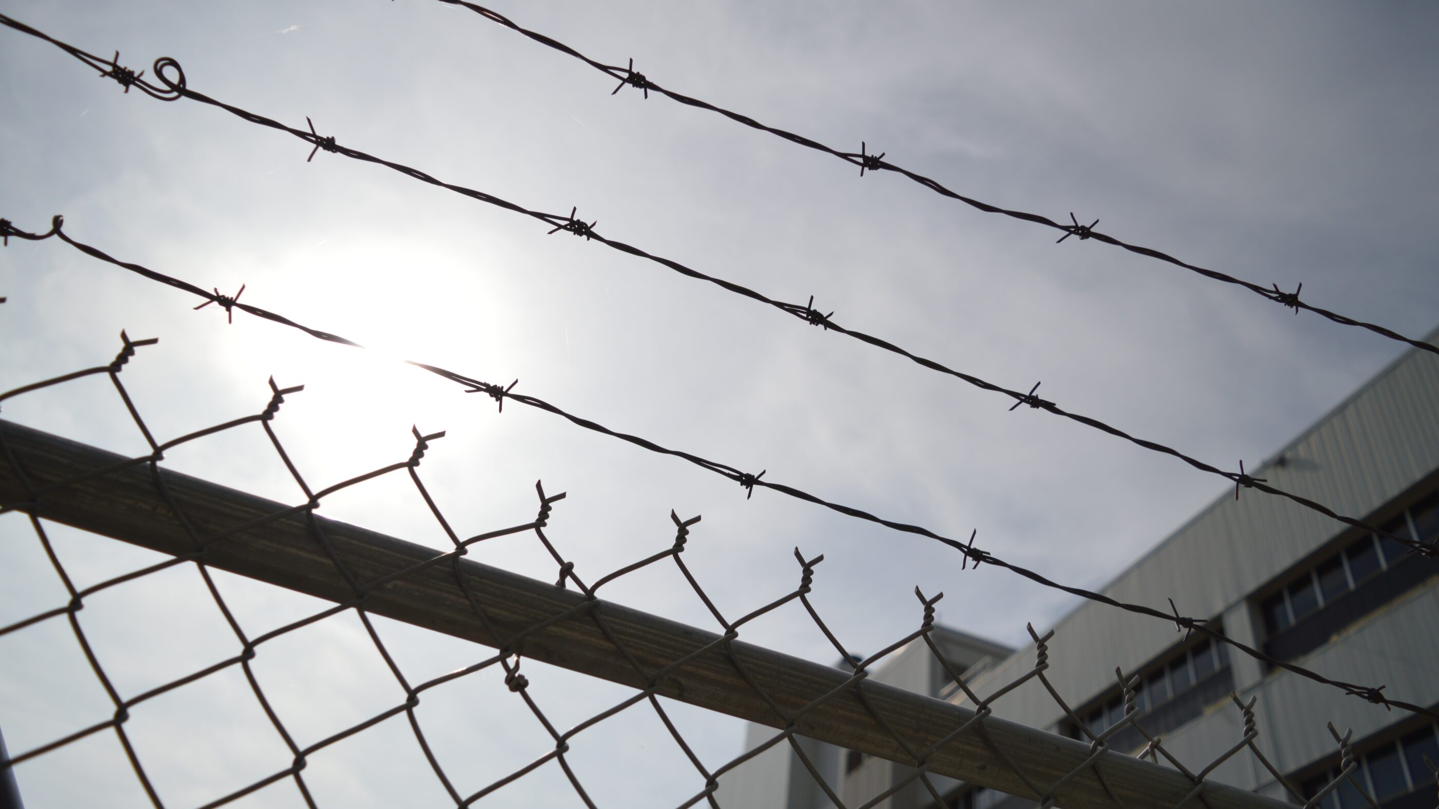 barbed wire on top of a fence