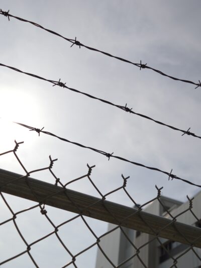 barbed wire on top of a fence