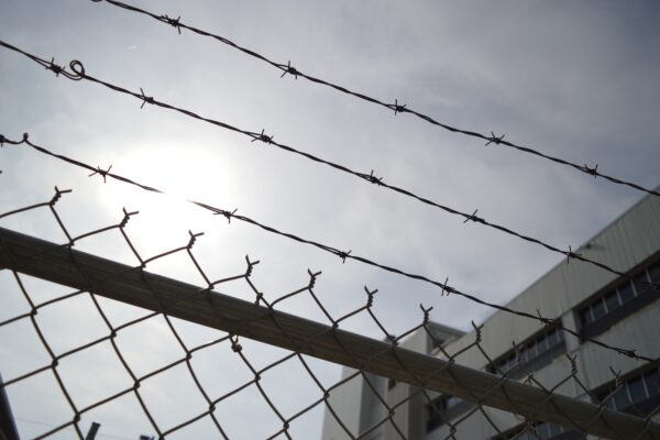 barbed wire on top of a fence