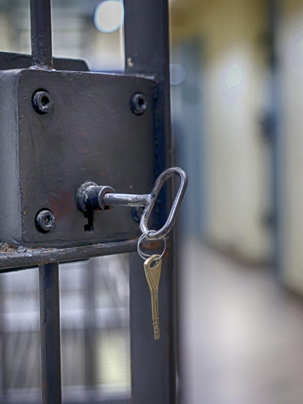 Open prison door with key in lock