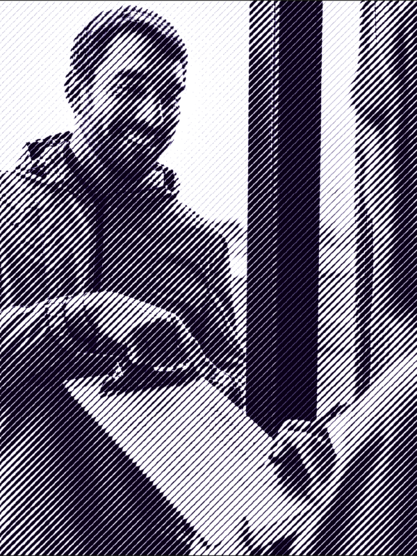 Man with brown hair and a beard holds a clipboard in front of a woman with medium length brown hair.