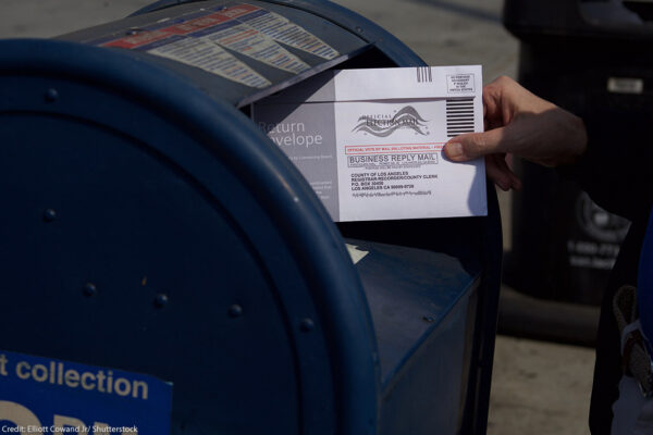 A mail in ballot placed in mail box.