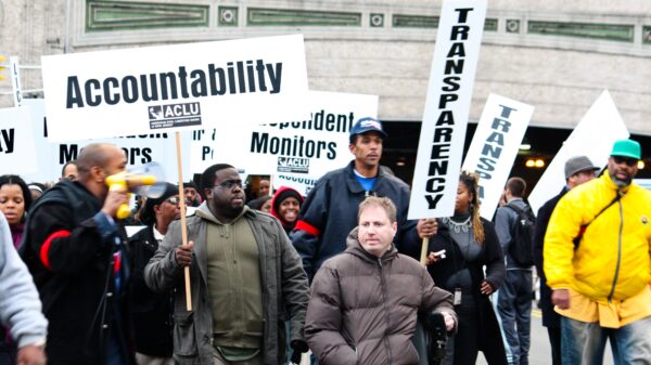 A group of protestors holding signs with "accountability" and "Transparency" in Newark, NJ.