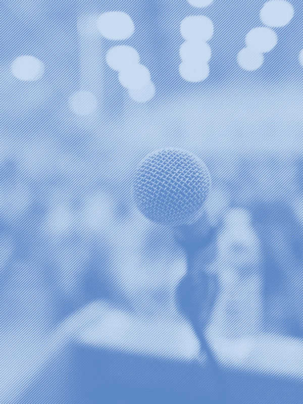 A mircophone on a podium with a crowd of people in the background with a blue strip treatment