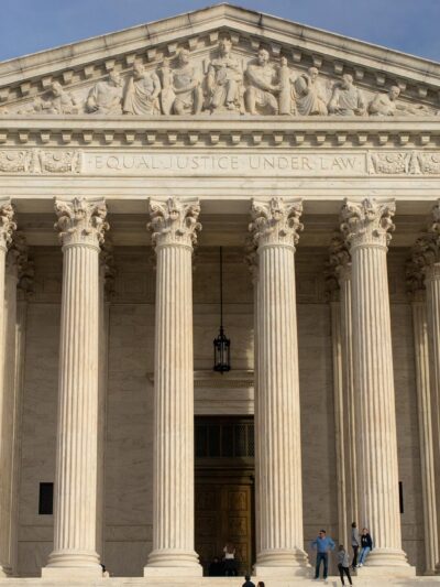 The facade of the Supreme Court of the United States building against a blue sky,