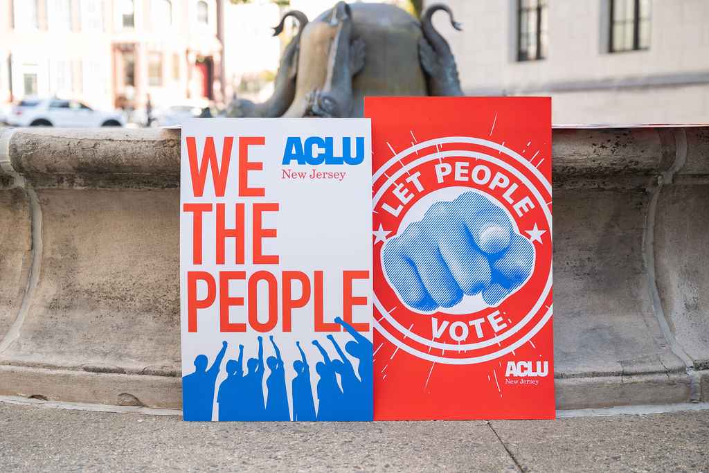 Signs that read "We the People" and "Let People Vote"