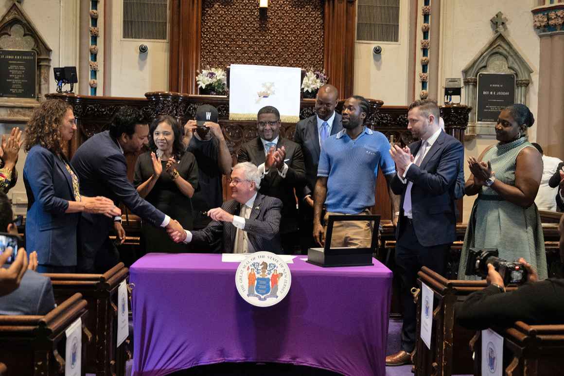 Governor Phil Murphy shaking hands with ACLU-NJ Executive Director Amol Sinha after signing Clemency Executive Order