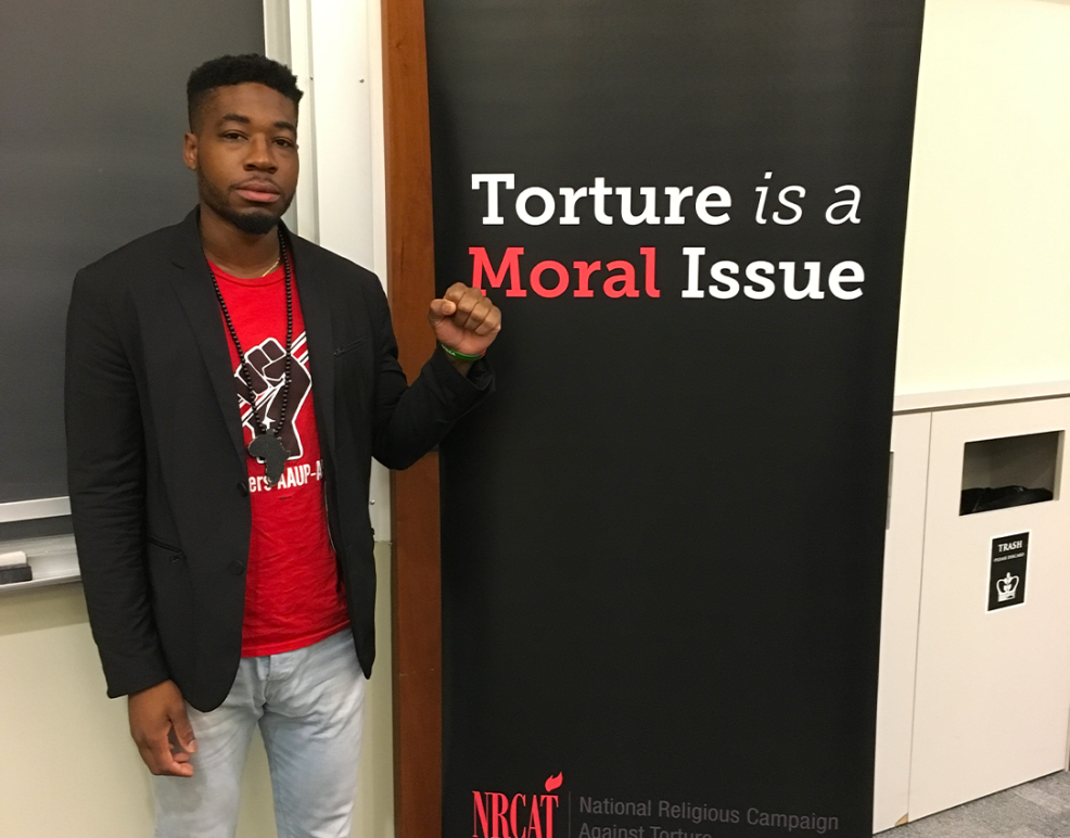 Mark Hopkins, a survivor of solitary confinement, stands next to the words "Torture is a Moral Issue."