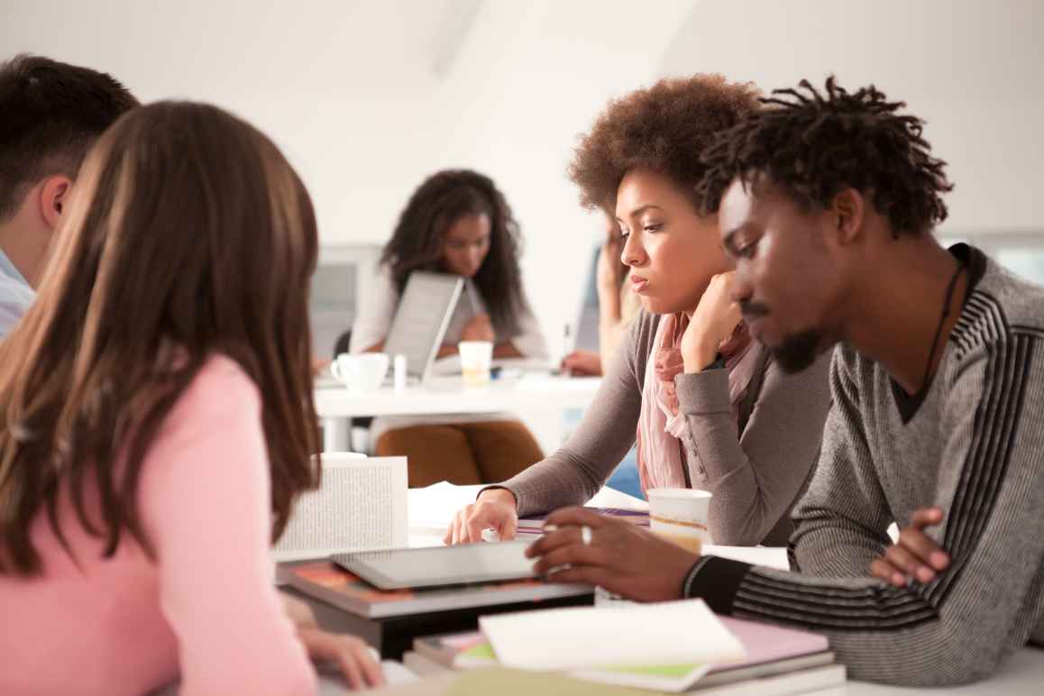 Multi-ethnic group of college students studying 