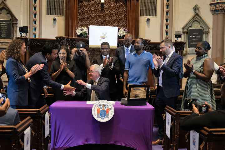 ACLU-NJ Executive Director shakes hands with New Jersey Governor Phil Murphy at the Clemency Executive Order Announcement.