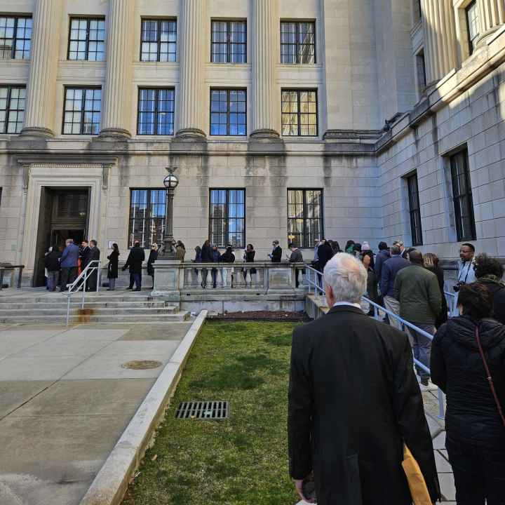 A line of people waiting to testify at the OPRA hearing wraps around the State House.