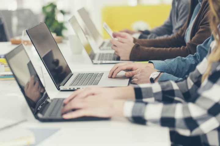 students on laptops in a classroom