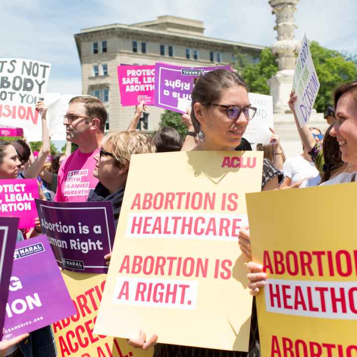 Protestors holding signs reading "abortion is healthcare. Abortion is a right"