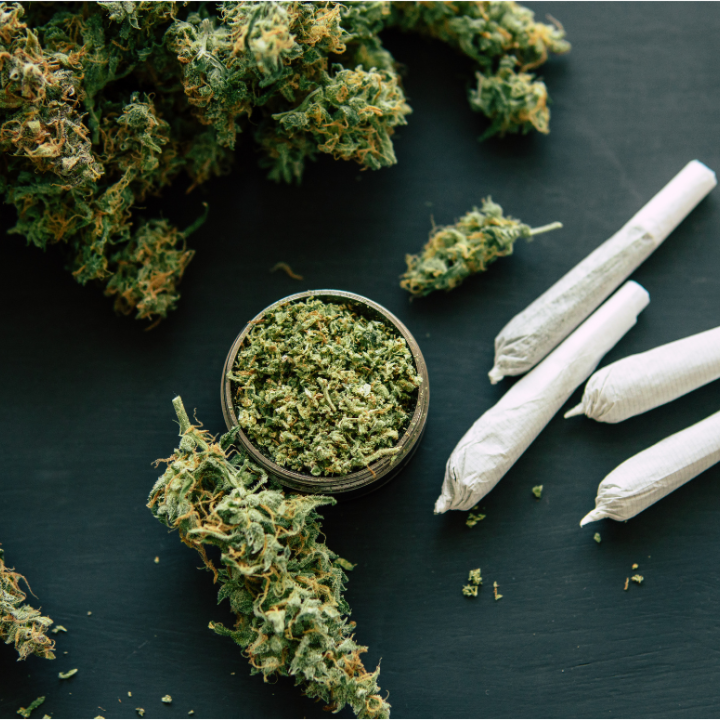 Joint and Grinder bud cannabis with crushed cannabis flowers 