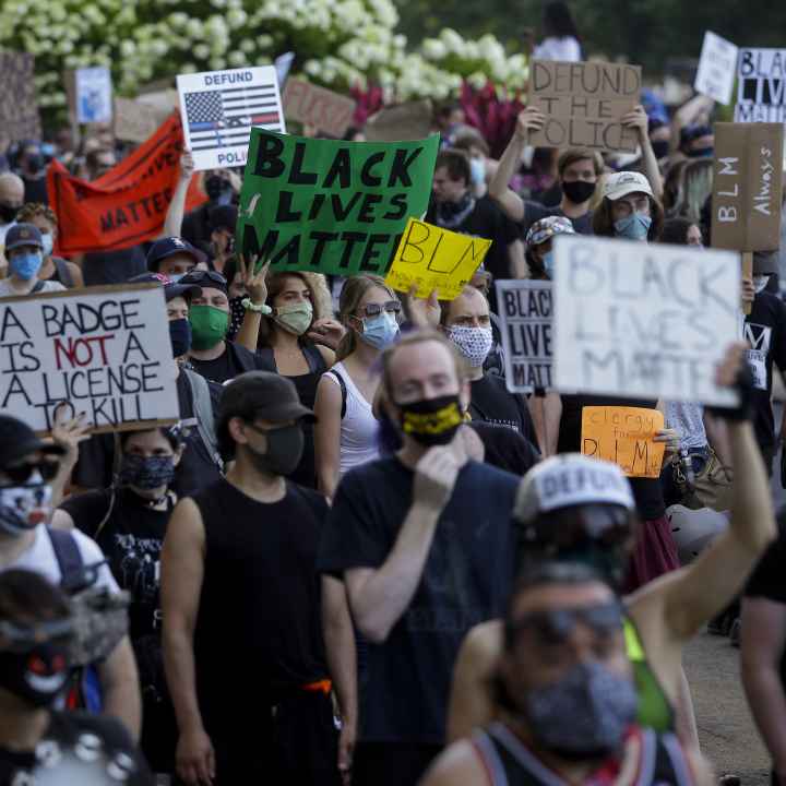Protesters holding signs