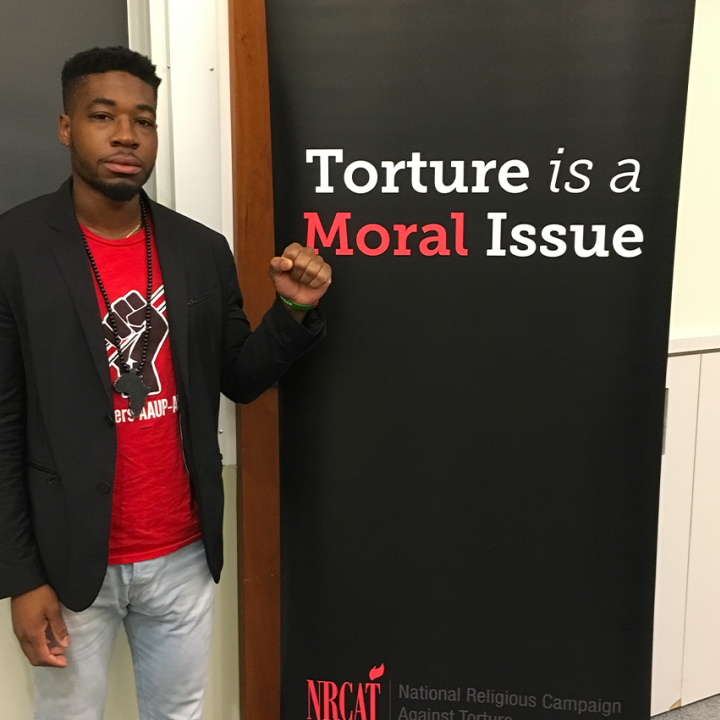Mark Hopkins, a survivor of solitary confinement, stands next to the words "Torture is a Moral Issue."