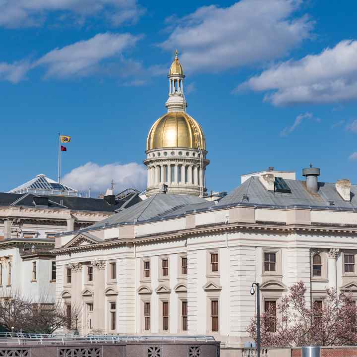 A photo of the New Jersey State House in Trenton on a sunny day.