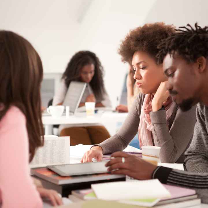 Multi-ethnic group of college students studying 