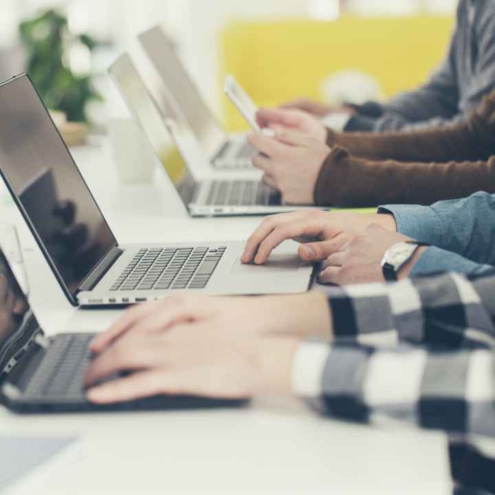 students on laptops in a classroom